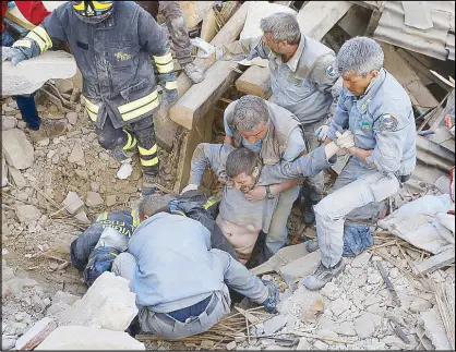  ??  ?? A man is rescued from the ruins following an earthquake in Amatrice, central Italy yesterday. REUTERS