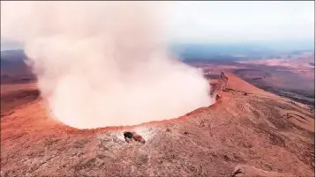  ?? U.S. REP. TUSLI GABBARD/NATIONAL GUARD VIA AP ?? IN THIS MAY 5 PHOTO PROVIDED BY U.S. REP. TULSI GABBARD, who is on active duty Hawaii National Guard deployment, ash from the Puu Oo vent on Kilauea volcano rises into the air, near Pahoa, Hawaii. Hawaii’s erupting Kilauea volcano has destroyed homes...