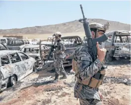  ?? VICTOR J. BLUE/THE NEW YORK TIMES ?? Armed with American weapons seized from Afghan soldiers, members of a Taliban unit patrol a former CIA base on Sept. 6 in Kabul, Afghanista­n.