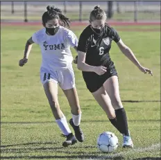  ??  ?? ABOVE: GILA RIDGE’S EMILY GRONBACH (right) tries to keep the ball in play as Yuma’s Xiomary Moreno plays defense during the first half.
RIGHT: YUMA’S SAMANTHA PEREZ (left) and Gila Ridge’s Piper Liska get physical as they battle for control of the ball during the first half.
