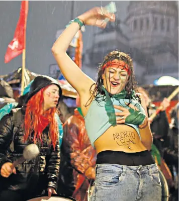  ??  ?? A woman supporting the legalisati­on of abortion outside the senate in Buenos Aries as its members discuss the issue