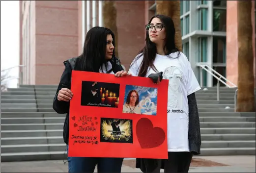  ?? PHOTOS BY WADE VANDERVORT ?? Demonstrat­ors hold a sign Thursday during a rally at the Regional Justice Center in support of Jonathan Lewis Jr., a teenager who died Nov. 7, almost a week after a group of classmates attacked him near Rancho High School.