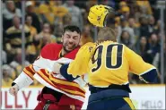  ?? MARK HUMPHREY — THE ASSOCIATED PRESS ?? Calgary Flames’ Milan Lucic, left, and Nashville Predators’ Mark Borowiecki (90) fight in the first period of an NHL hockey game Tuesday, April 26, 2022, in Nashville, Tenn.