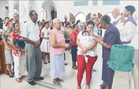  ?? (Orlando Charles photo) ?? Ash Wednesday: Persons of all ages turned up at the Cathedral of the Immaculate Conception, Brickdam to be anointed with ash on the first day of Lent yesterday.