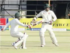  ?? — AP ?? HARARE: Zimbabwean batsman Brian Chari, left, and Craig Ervine make a quick run during the match between Zimbabwe and Sri Lanka at Harare Sports Club in Harare, yesterday.