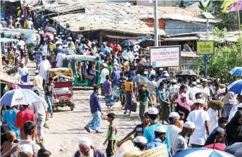  ?? — AFP file photo ?? Rohingya refugees gather at a market as first cases of Covid-19 coronaviru­s have emerged in the area, in Kutupalong refugee camp in Ukhia, Bangladesh.