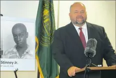  ?? Bruce Smith/Associated Press ?? Attorney and law professor Miller Shealy stands Friday in front of a photo of George Stinney, one of the youngest defendants executed in American history and the youngest executed in the 20th century.