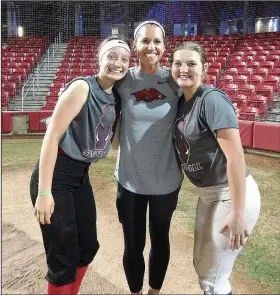  ?? Contribute­d photo ?? Happy campers: Smackover's Karli Goocher, left, and Lydia Pullin pose with Arkansas softball coach Courtney Deifel. The juniors attended the Arkansas Elite All-Skills Camp in Fayettevil­le recently. Both Lady Bucks are busy this summer planting seeds for their future in softball.