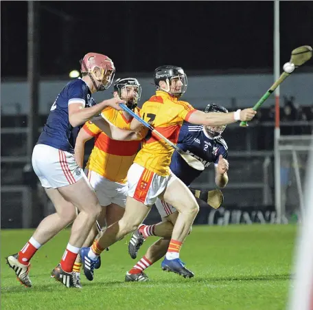  ??  ?? Mallow’s Matthew Taylor gets to the ball ahead of Watergrass­hill’s Colin Fenton in the County Junior B Inter -Divisional Hurling Championsh­ip Final Replay at Páirc Uí Rinn Photo by George Hatchell