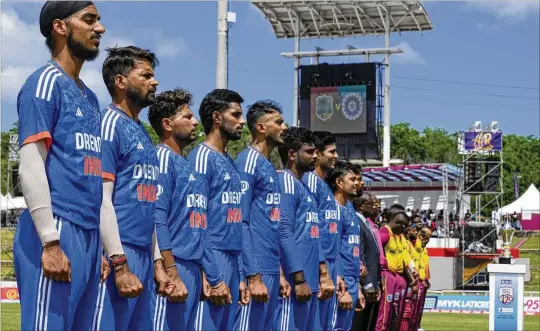  ?? PHOTOS BY RAMON ESPINOSA/ASSOCIATED PRESS ?? Players on India’s cricket team line up for the national anthem before their first T20 match against the West Indies in Tarouba, Trinidad and Tobago. T20 is a condensed, threehour form of the game that has boomed in India, making the 15-year-old Indian Premier League the world’s most lucrative sports league.