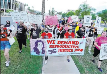  ?? Ross D. Franklin
The Associated Press file ?? Thousands march around the Arizona Capitol in protest in June 2022 after the Supreme Court decision to overturn the landmark Roe v. Wade abortion decision.