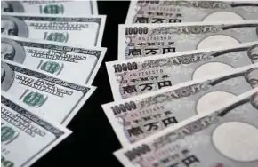  ??  ?? Mata wang yen mula mengatasi dolar AS selepas Bank of Japan berkata ia akan mengurangk­an pembelian bonnya.