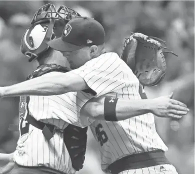  ?? BENNY SIEU / USA TODAY SPORTS ?? Brewers pitcher Corey Knebel (right) hugs catcher Stephen Vogt after picking up a save against the Philadelph­ia Phillies at Miller Park on Saturday night. The Brewers beat the Phillies, 3-2.