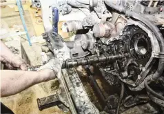  ??  ?? As the camshaft was being pulled, Bosie was extremely careful not to damage any of the bearings. And, because having a lifter drop after the camshaft is removed means you’re pulling the oil pan, Bosie inserted a 1.5-inch diameter pipe in the cam’s bore as soon as the cam was out for added insurance.