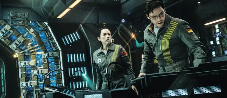  ?? SCOTT GARFIELD / NETFLIX VIA THE ASSOCIATED PRESS ?? Ziyi Zhang and Daniel Bruhl in a scene from the sci-fi movie The Cloverfiel­d Paradox, which was released by Netflix as a surprise just after the Super Bowl.