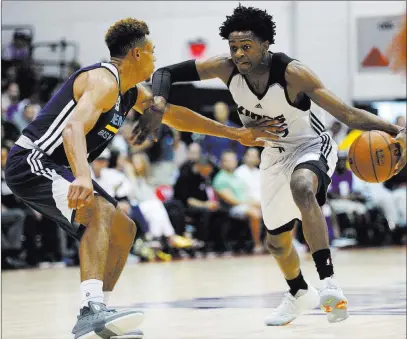  ?? Rachel Aston ?? Las Vegas Review-journal @rookie__rae Sacramento Kings guard De’aaron Fox drives on Memphis Grizzlies guard Wade Baldwin IV during their NBA Summer League game Sunday at UNLV’S Cox Pavilion.