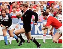  ??  ?? Tournament star: John Kirwan surges away from the Wales defence in the All Blacks’ semi-final win in Brisbane.