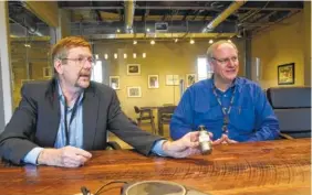  ?? STAFF PHOTO BY TIM BARBER ?? Steward Advanced Materials Inc. president Tim Armstrong, left, holds an example of the 316 L stainless steel flake alongside Scott Smith, senior vice president, as they talk about the tradition of the long-time family owned Chattanoog­a business.