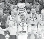  ?? THANASSIS STAVRAKIS/AP ?? Goran Dragic lifts the trophy after defeating Serbia in the Eurobasket European Basketball Championsh­ip final.