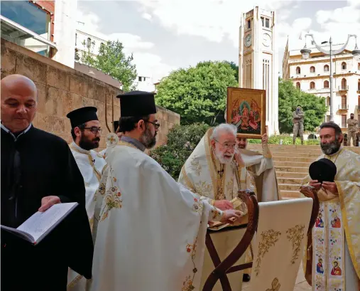  ?? AFP ?? If the number continues to decrease, this means that we are in control of the pandemic in Lebanon.
Dr. Abdul-Rahman Al-Bizri
Lebanese
Greek Orthodox Archbishop for the Archdioces­e of Beirut, Metropolit­an,
Elias Audi, center, holds a crowd-less Easter service due to the COVID-19 pandemic, at the St. George Church at Nejmeh Square in downtown Beirut, on Sunday.