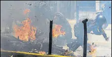  ?? AFP ?? Police react after an explosion while they were riding past a protest against the elections for a Constituen­t Assembly in Caracas.