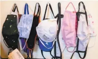  ?? Jessica Christian / The Chronicle ?? Masks hang in the foyer of UCSF physician Dr. Madhavi Dandu’s San Francisco home.