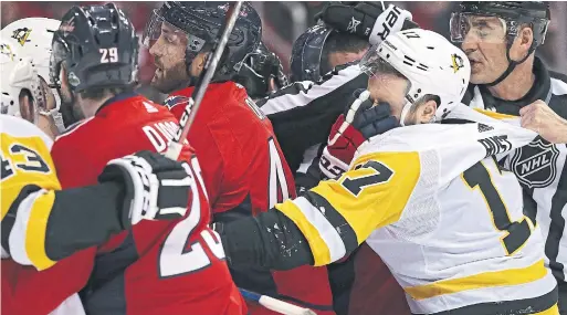  ?? PATRICK SMITH/GETTY IMAGES ?? Pittsburgh Penguins winger Bryan Rust is face-washed as teammates scrum with Washington Capitals players during the first period in Washington, D.C., on Sunday.