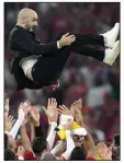  ?? (AP/Natacha Pisarenko) ?? Morocco Coach Walid Regragui is thrown in the air by his players after the team defeated Canada 2-1 in its World Cup match Thursday at Al Thumama Stadium in Doha, Qatar. More photos at arkansason­line. com/122wcup22/