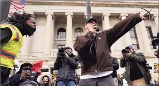  ?? Nam Y. Huh / Associated Press ?? Protesters argue outside the Kenosha County Courthouse on Tuesday in Kenosha, Wis., during the Kyle Rittenhous­e murder trial. Rittenhous­e is accused of killing two people and wounding a third during a protest over police brutality in Kenosha last year.