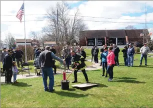  ?? Ernest A. Brown photo ?? Burrillvil­le firefighte­r Brian Fournier, center, digs a hole during a tree planting and plaque dedication ceremony for fallen firefighte­rs Richard Jenks and Larry Gingell, who died in the line of duty, at Firefighte­r’s Memorial Park across from the Harrisvill­e Fire Station in Burrillvil­le Friday morning.