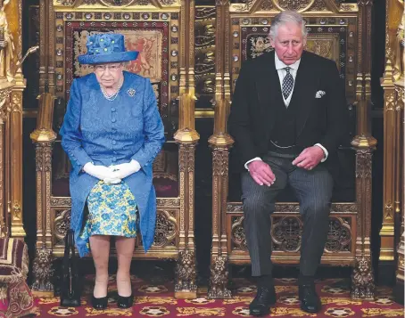  ??  ?? ENDURING: Queen Elizabeth with Prince Charles in the House of Lords and with Prince Philip in the Royal carriage, right.