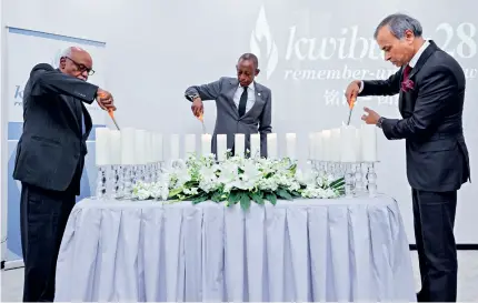  ?? ?? Rwanda’s Ambassador to China James Kimonyo (middle), African Union’s Permanent Representa­tive in China Rahamtalla Mohamed Osman (left) and UN Resident Coordinato­r in China Siddharth Chatterjee light candles in memory of the victims during the 28th commemorat­ion of the genocide against the Tutsi in Rwanda on April 7 in Beijing