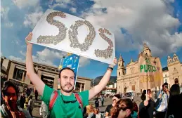  ?? –AFP ?? Activists gather at the Bolivar Square to demand the Colombian government take action on climate change as part of Global strike for future in Bogota on Friday. The protest was held in support of Swedish climate change activist Greta Thunberg.