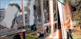  ?? PHOTO / LEWIS GARDNER ?? South Taranaki District Council maintenanc­e officer Darryl Wereta was forced to repair several smashed windows on Pa¯ tea LibraryPlu­s in April.