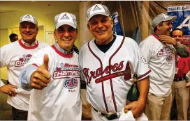  ?? CURTIS COMPTON / AJC FILE ?? Then-Braves GM John Schuerholz (giving the thumbs up) and manager Bobby Cox celebrate the team’s 13th straight division championsh­ip in 2004.