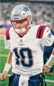  ?? Bryan Woolston/Associated Press ?? Patriots quarterbac­k Mac Jones leaves the field after Sunday’s loss to the Giants.