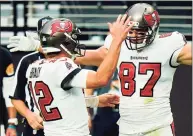  ?? Jeff Bottari / Associated Press ?? Buccaneers tight end Rob Gronkowski (87) celebrates with quarterbac­k Tom Brady, left, after scoring a touchdown against the Raiders on Oct. 25.