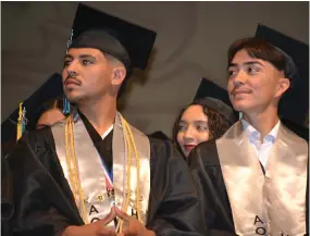  ?? ?? Valedictor­ian Emilio Valencia (left) and Class President Joshua Joven (right) listen intently during the Harmony Magnet Academy graduation ceremony on Friday at the Buck Shaffer Theater at the Portervill­e Memorial Auditorium.