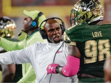  ?? Jason Behnken / Associated Press ?? South Florida coach Charlie Strong, left, has the Bulls off to the best start in school history and a No. 17 ranking. Strong was 16-21 in three seasons as head coach at Texas before coming to Tampa, Fla., last winter.