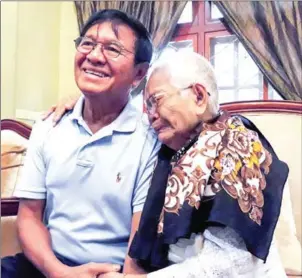  ?? AFP ?? Kem Sokha sits with his mother while under court-supervised bail at his residence in Phnom Penh on September 11. A joint report released by three NGOs found that government critics like Sokha have been ‘surpressed with increasing frequency and severity’.