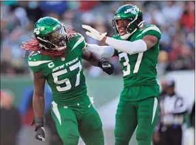  ?? Adam Hunger / Associated Press ?? LB C.J. Mosley (57) and CB Bryce Hall (37) are two of the Jets key players on defense.