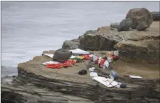  ?? AP PHOTO/DENIS POROY ?? Items from a boat sit on the shoreline at Cabrillo National Monument near where it capsized just off the San Diego coast Sunday in San Diego. Authoritie­s say two people were killed and nearly two dozen others were hospitaliz­ed after the boat capsized.