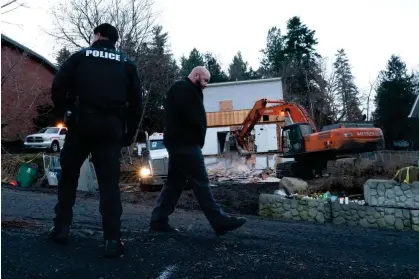  ?? Photograph: Ted S Warren/AP ?? Heavy equipment is used to demolish the house on Thursday in Moscow, Idaho.