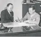  ?? AP ?? Halas watches Red Grange sign a deal to act as the Bears’ backfield coach in 1935.