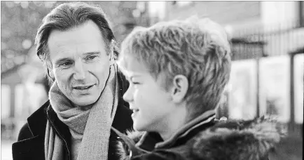  ??  ?? Sam (Thomas Sangster) opens up to his stepfather Daniel (Liam Neeson) about the vagaries of love in Richard Curtis' romantic comedy “Love Actually.”