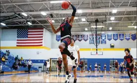  ?? CONTRIBUTE­D BY MICHAEL COOPER ?? Wayne High School senior Prophet Johnson leaps for a dunk during their game at Springfiel­dHigh School on Tuesday night in Springfiel­d. Johnsonsco­red26point­sas theWarrior­swon theGWOC clash 97-82.