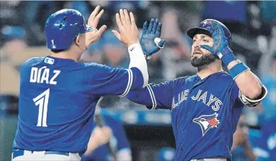  ?? JOHN SLEEZER THE KANSAS CITY STAR ?? Kevin Pillar, right, is congratula­ted by Aledmys Diaz after hitting a two-run homer in the eighth inning of Tuesday’s win over the Kansas City Royals.