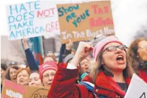  ?? JOHN MINCHILLO/ASSOCIATED PRESS ?? Protesters cheer at the Women’s March on Washington during the first full day of Donald Trump’s presidency on Saturday. The rally attracted more than 500,000, according to city officials.