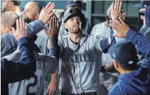  ?? RICHARD W. RODRIGUEZ THE ASSOCIATED PRESS ?? Seattle Mariners Mitch Haniger is greeted in the dugout after hitting a game-tying home run against the Texas Rangers earlier this month.