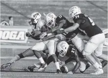  ?? PHOTO BY MARK GILLILAND ?? UT-Martin’s Lardarius Galloway gets tackled by UTC’s Tae Davis and Taylor Reynolds during a game in September.